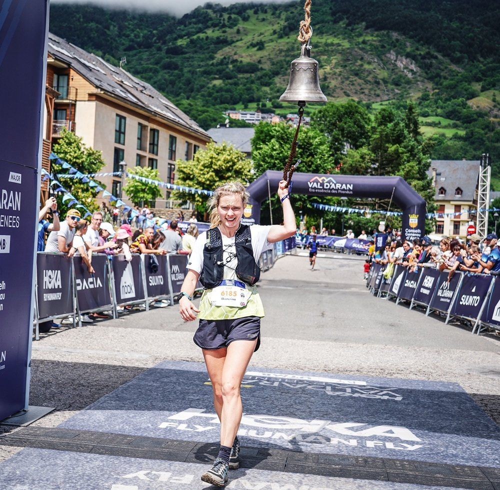 Kat Townshend ringing the finish bell at Val d'Aran by UTMB