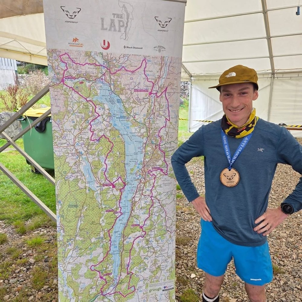 Ian with his medal in front of The Lap route map