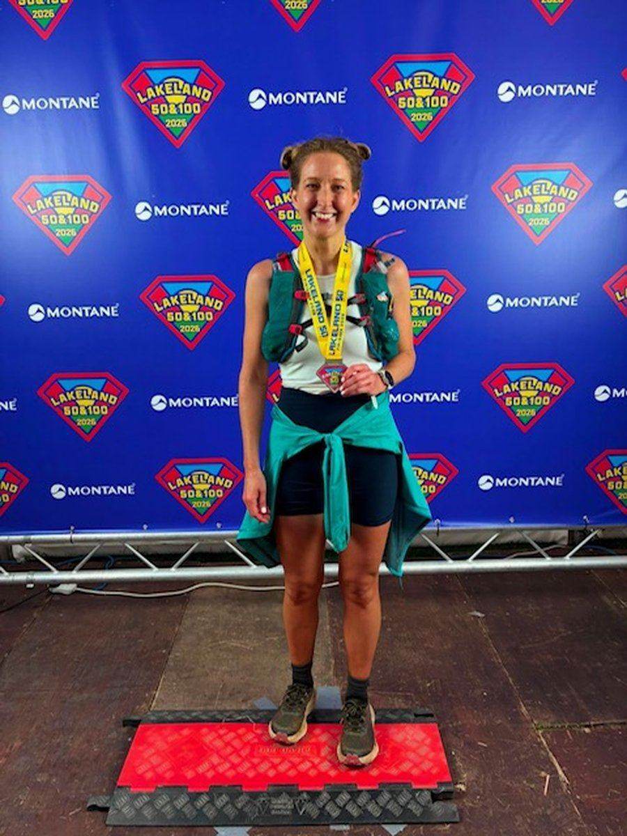 Lydia on the podium with her medal after finishing the Lakeland 50