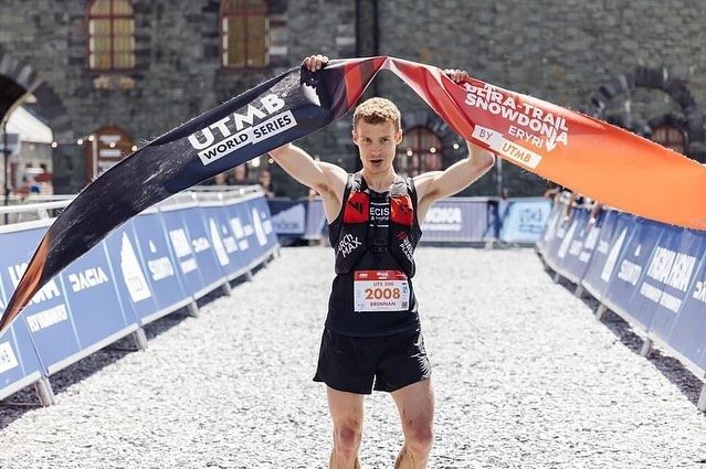 Brennan Townshend breaking the tape to win the UTS 50km at Ultra-Trail Snowdonia by UTMB